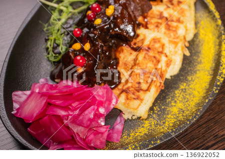 Fried meat with potato waffles and herbs on a Fried meat with potato waffles and herbs on a 136922052
