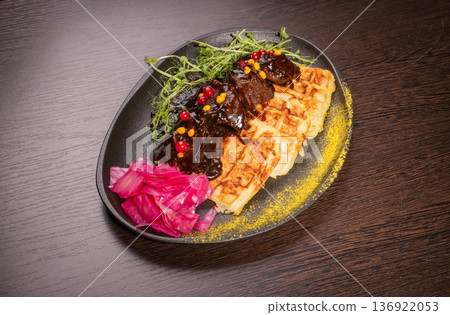 Fried meat with potato waffles and herbs on a Fried meat with potato waffles and herbs on a 136922053