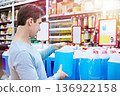 Man buys nonfreezing liquid in shop 136922158