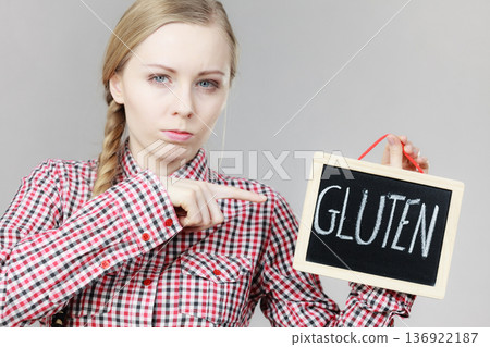 Woman holding board with gluten sign Woman holding board with gluten sign 136922187