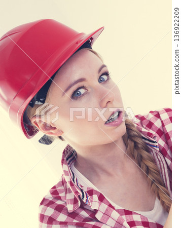 Shocked woman wearing helmet 136922209