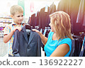 Mom chooses suit for little son 136922227