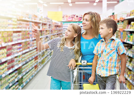 Family chooses products in shop 136922229