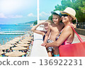 Family on vacation at sea walk along promenade 136922231