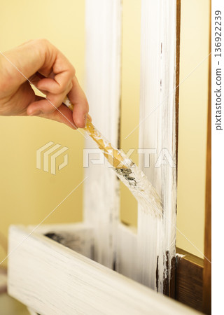 Person renovating wooden hanger 136922239