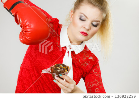 Woman boxing chocolate cupcake 136922259