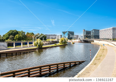 Berlin, germany, august 15, 2023. Berlin cityscape featuring the spree river, waterfront buildings, and the contemporary architecture of cube berlin on a clear day Berlin, germany, august 15, 2023. Berlin cityscape featuring the spree river, waterfront buildings, and the contemporary architecture of cube berlin on a clear day 136922287
