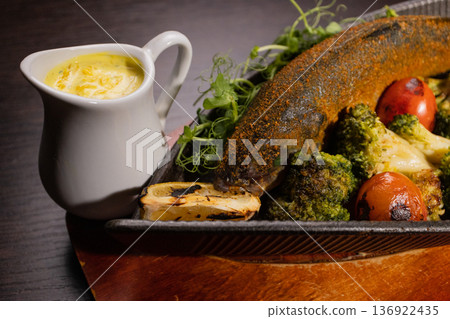 Baked fish with vegetables and sauce in a plate on Baked fish with vegetables and sauce in a plate on 136922435