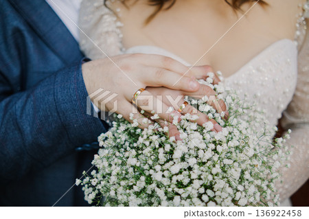 The bride and groom are holding a wedding bouquet The bride and groom are holding a wedding bouquet 136922458