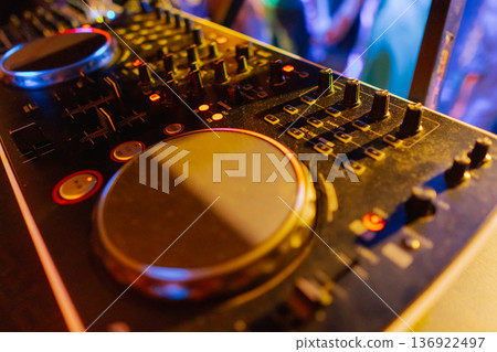 A DJ booth in the evening lights of a club A DJ booth in the evening lights of a club 136922497