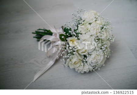 A wedding bouquet lies on a white parquet floor A wedding bouquet lies on a white parquet floor 136922515