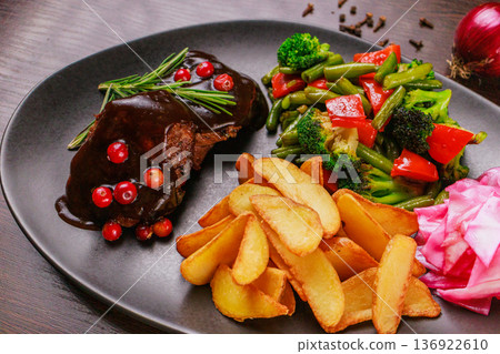 A plate of fried meat, fried potatoes and A plate of fried meat, fried potatoes and 136922610