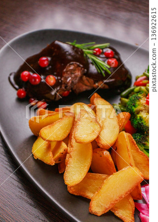 A plate of fried meat, fried potatoes and A plate of fried meat, fried potatoes and 136922615