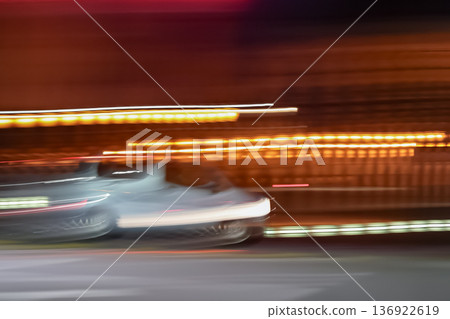 Panning shot of a car speeding through the night 136922619
