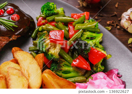 A plate of fried meat, fried potatoes and A plate of fried meat, fried potatoes and 136922627