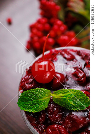 Dessert of pickled cherries with cream in a glass Dessert of pickled cherries with cream in a glass 136922653