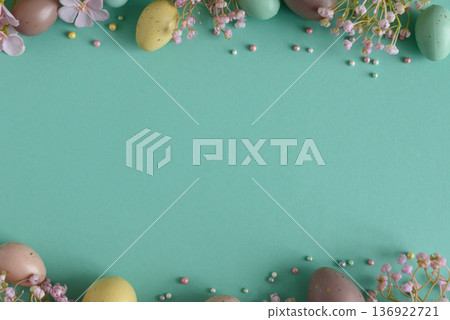 Pastel Easter Eggs and Flowers on Teal Background. Festive Spring Flatlay 136922721
