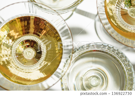 Top View on Several Champagne Glasses on White  Background. Birthday or Wedding Celebration Arrangement 136922730