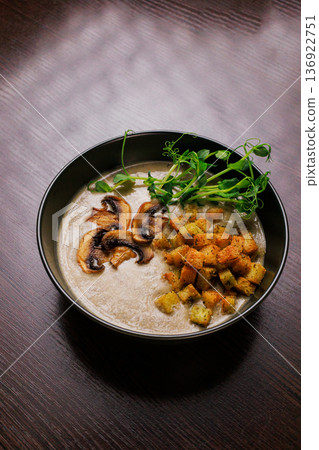 Cream soup with mushrooms and herbs in a black Cream soup with mushrooms and herbs in a black 136922751