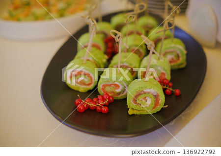 Appetizing rolls with red fish on a plate 136922792