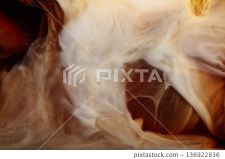 Cream is poured into a glass with iced coffee. 136922836
