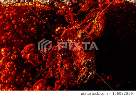 Carbonated drink is poured into a glass. Carbonated drink is poured into a glass. 136922839