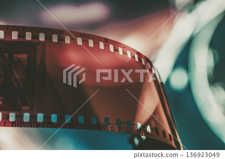 Film strip with grunge noise texture in close up, retro cinema frame with light leaks and analog scratches. Concept of vintage photography, film grain overlay, retro media background Film strip with grunge noise texture in close up, retro cinema frame with light leaks and analog scratches. Concept of vintage photography, film grain overlay, retro media background 136923049