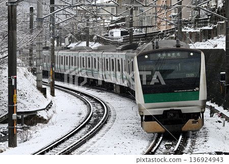 E233 series train running in the snow E233 series train running in the snow 136924943