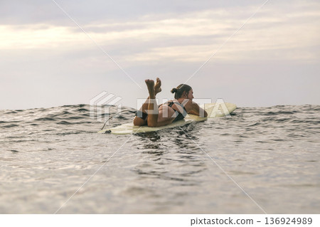 Serene Seaside Setting With Woman Watching Horizon And Relaxing 136924989