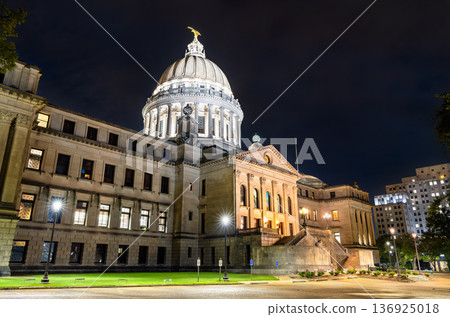 Mississippi State Capitol building stands in Jackson, USA. Historic Beaux-Arts architecture features the illuminated dome and stone columns under a dark night sky 136925018
