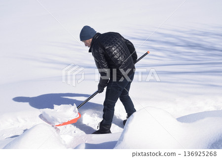 Snow removal by an elderly man living in a heavy snow area Snow removal by an elderly man living in a heavy snow area 136925268
