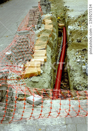 Street Repair Work in Progress With Construction Materials and Safety Barriers Street Repair Work in Progress With Construction Materials and Safety Barriers 136925534