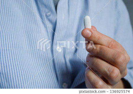 One big pill in woman hand close up. Healthcare and medicine, vitamins and dietary supplements. One big pill in woman hand close up. Healthcare and medicine, vitamins and dietary supplements. 136925574