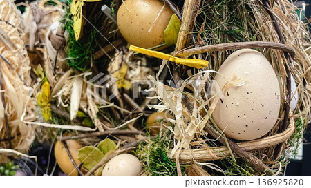 Decorative bird nest with speckled eggs, moss and dry twigs, rustic natural Easter background. Decorative bird nest with speckled eggs, moss and dry twigs, rustic natural Easter background. 136925820