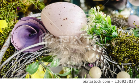Beautiful Easter wreaths with spring flowers, speckled eggs and feathers, festive holiday decor. 136925837