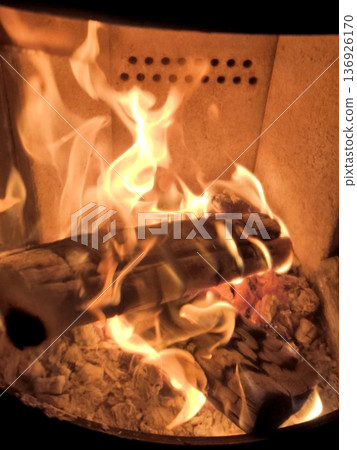 Close-up of a blazing fire and burning logs in a modern fireplace 136926170