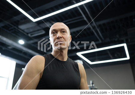 Muscular athletic man portrait in modern fitness gym 136926430