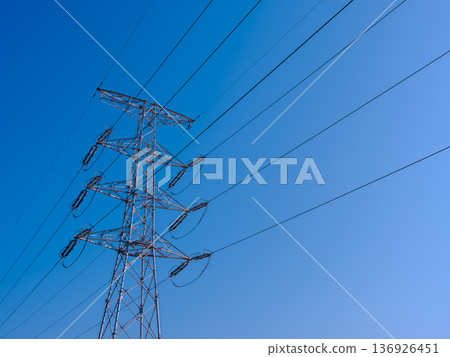 Power lines and towers stretching into the blue sky - an image of power infrastructure 136926451