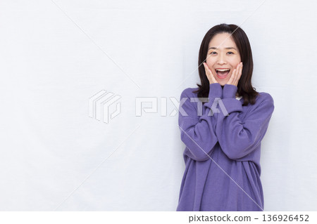 Smiling and surprised woman 136926452