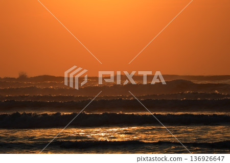 A sea stained in a morning glow 136926647