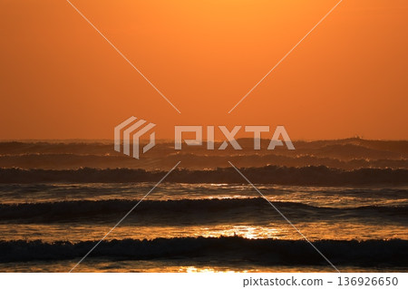 A sea stained in a morning glow 136926650