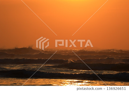 A sea stained in a morning glow 136926651