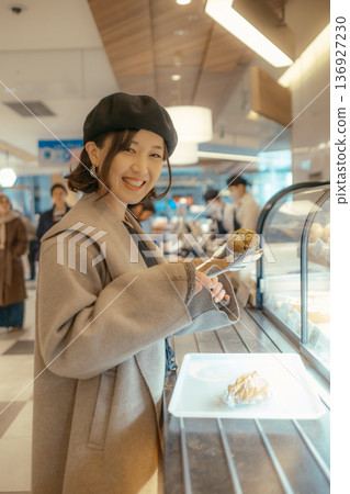 Japanese woman choosing bread at a bakery 136927230