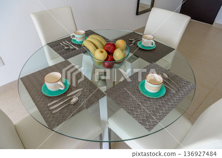 Glass dining table with place settings overhead view Glass dining table with place settings overhead view 136927484