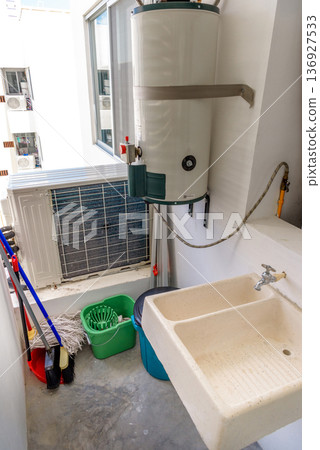 Utility room with water heater air conditioner and cleaning supplies Utility room with water heater air conditioner and cleaning supplies 136927533