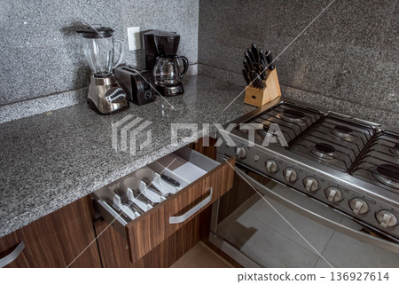 Open kitchen drawer showing organized cutlery and utensils Open kitchen drawer showing organized cutlery and utensils 136927614