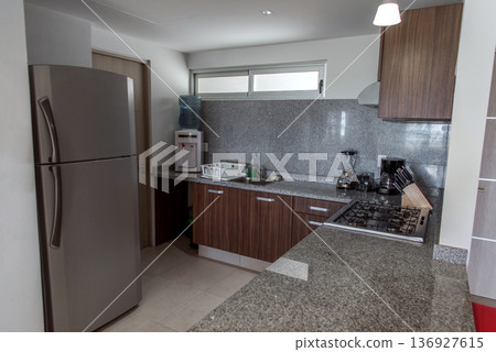 Modern kitchen with granite counters and wood cabinets view Modern kitchen with granite counters and wood cabinets view 136927615