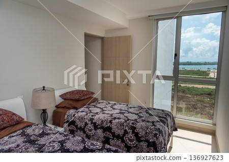 Contemporary bedroom with panoramic lake view through floor to glass doors Contemporary bedroom with panoramic lake view through floor to glass doors 136927623