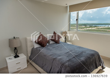 Comfortable double bed with scenic window view 136927639