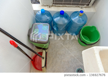 Utility storage area with water containers and cleaning tools Utility storage area with water containers and cleaning tools 136927676